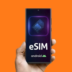 Hand holding an Android smartphone with eSIM displayed on the screen