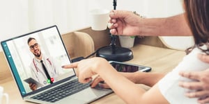 Telehealth consultation with a doctor on a laptop screen