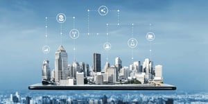 Smart city with IoT icons connecting buildings and technologies, emerging from a smartphone