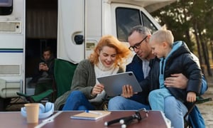 Family using mobile internet for home and travel outside their RV.