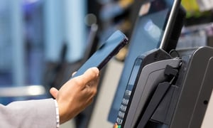 Customer making a contactless payment at a POS terminal