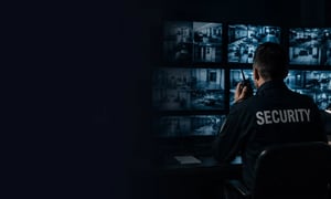 Security operator monitoring surveillance cameras