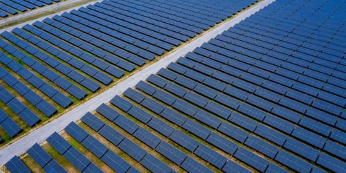 Aerial view of rows of solar panels in a large solar farm Aerial view of rows of solar panels in a large solar farm