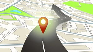 A digital map with a red location pin and a road emerging from it