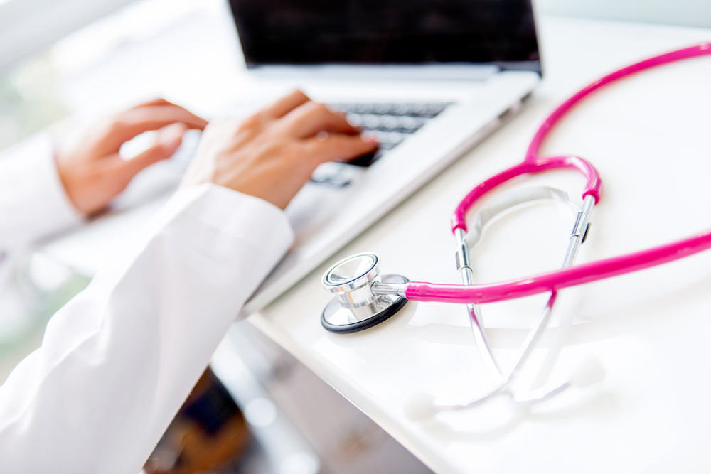 Doctor working on a laptop at the office-1 Doctor working on a laptop at the office-1